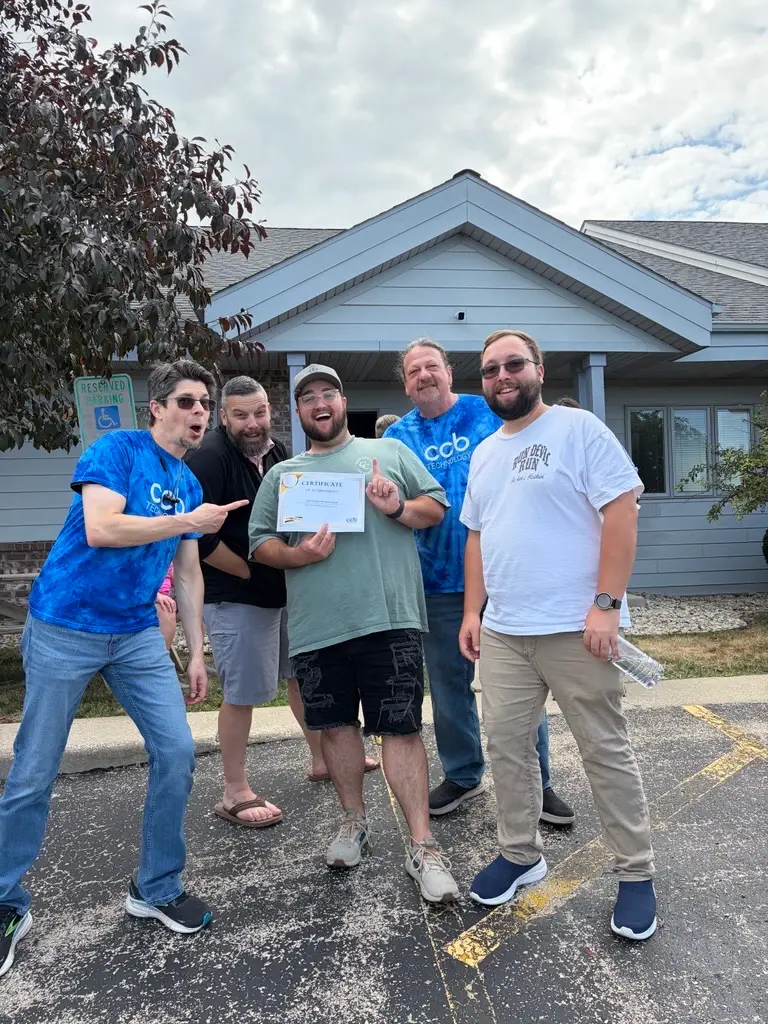 CCB Technology team members celebrating together outside the office